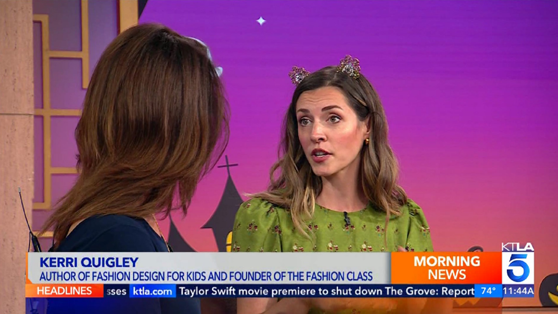 Two women are engaged in a conversation on a morning news program. One woman, identified as Kerri Quigley, wears a green shirt with a headband. She is the author of "Fashion Design for Kids" and the founder of The Fashion Class. The description on the news ticker provides information about her book.